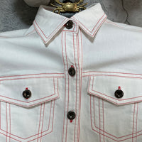 red stitched white denim style shirt