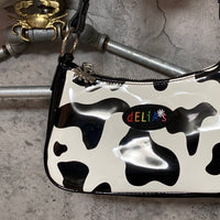 cow patterned enamel handbag white black